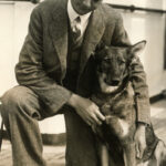 Morris Frank kneeling with buddy